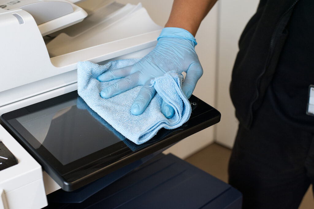 A NuServe cleaner disinfecting IT equipment.