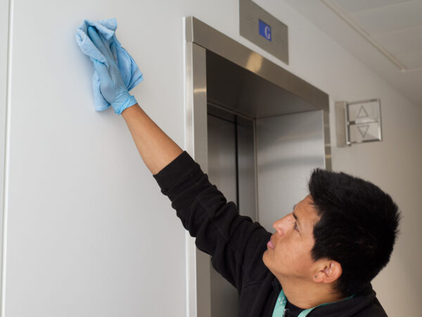 A NuServe cleaner wiping walls.