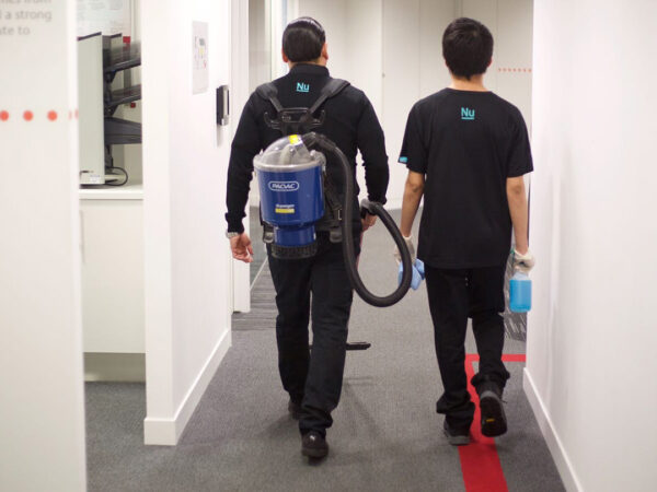 Two NuServe operatives with cleaning equipment.