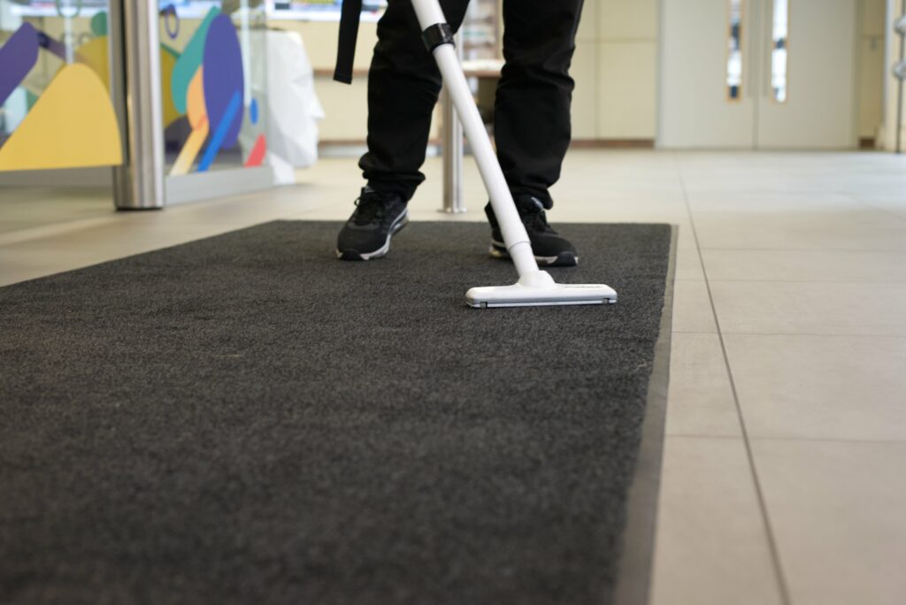 Vacuuming a rug.