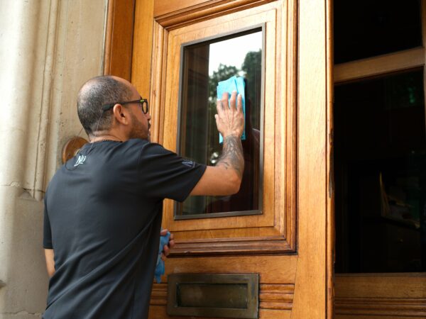 A NuServe operative cleaning windows.