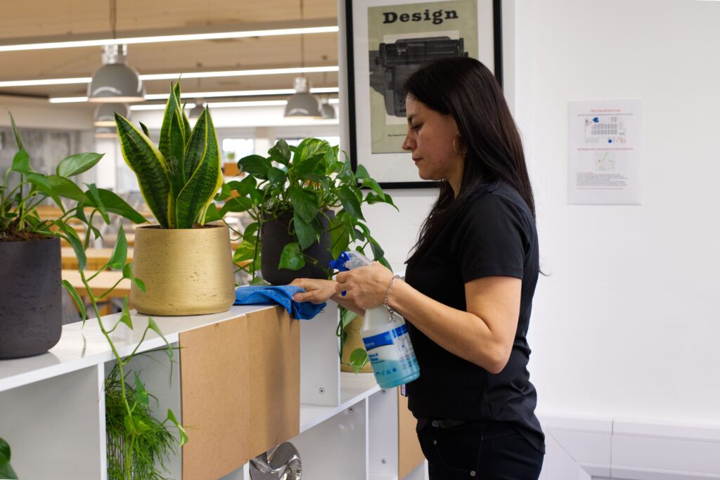 A NuServe cleaner wiping a shelf.