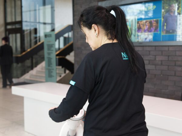 A NuServe operative using a floor scrubber.