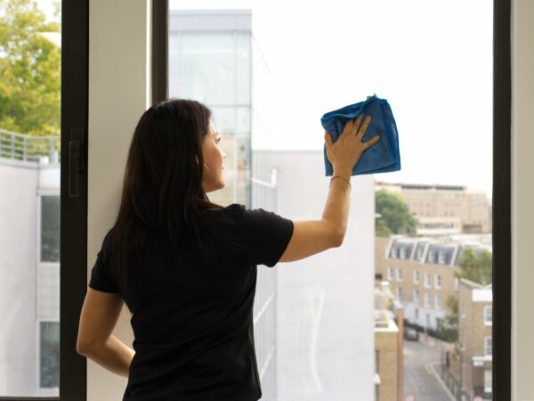 A NuServe operative cleaning windows.