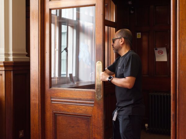 A NuServe operative cleaning a window.